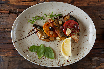 Image showing The fried mackerel with vegetables. Shallow dof.