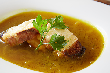 Image showing Onion soup in the ceramic pot. Shallow dof.