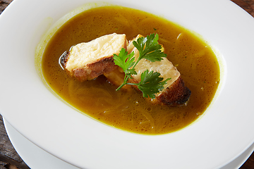 Image showing Onion soup in the ceramic pot. Shallow dof.