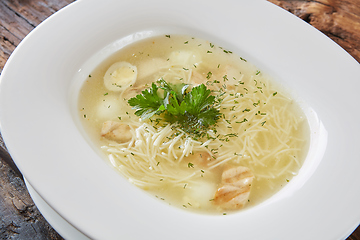 Image showing Chicken soup with noodles and vegetables in white bowl