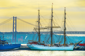 Image showing Ship by bridge at sunset