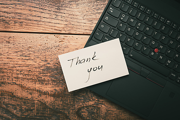 Image showing Closeup of Thank You sticky note message on laptop