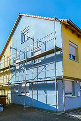 Image showing Modern house under construction with scaffold pole platform. 