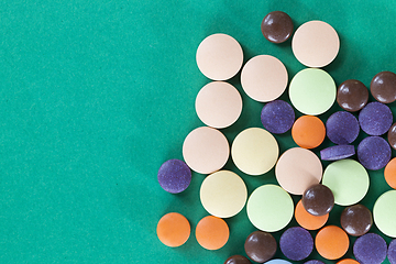 Image showing Multi-colored pills on a green background