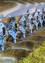Image showing blue steel plows during tillage, field Agricultural.