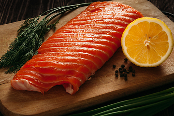 Image showing Fresh salmon piece on wooden board