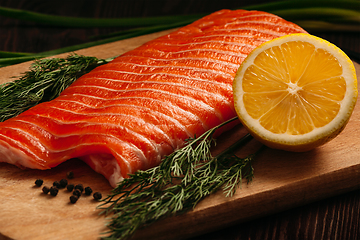 Image showing Fresh salmon piece on wooden board