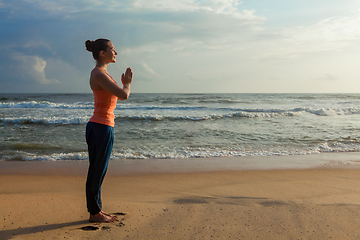 Image showing Woman doing yoga on beach