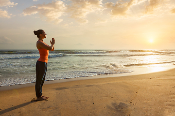 Image showing Woman doing yoga on beach