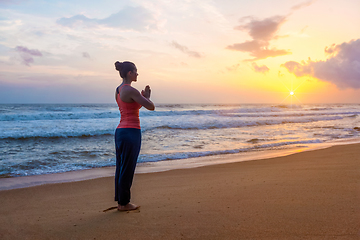 Image showing Woman doing yoga on beach