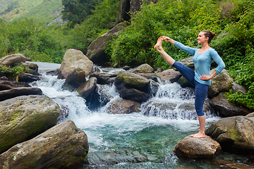 Image showing Woman doing Ashtanga Vinyasa Yoga asana outdoors at waterfall