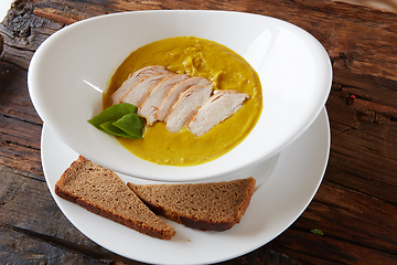 Image showing Pumpkin and carrot soup with chicken. Top view. Copy space.