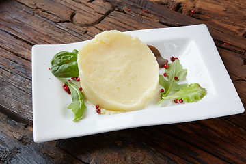 Image showing Potato Mash on rustic wooden background. Close-up shot.