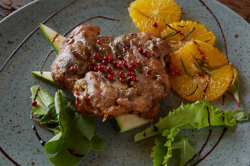 Image showing Chicken Steak with oranges and greens. Shallow dof.