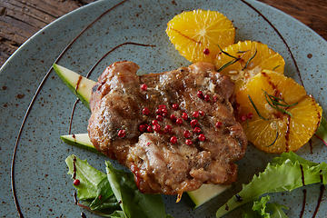 Image showing Chicken Steak with oranges and greens. Shallow dof.