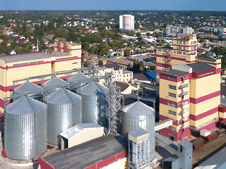 Image showing Agricultural Silo. Storage and drying of grains, wheat, corn, soy, against the blue sky with clouds.