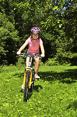 Image showing Teenage girl on a bicycle