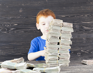 Image showing Boy and money tower