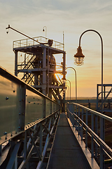 Image showing grain silo and dryer at night with pile of grain.