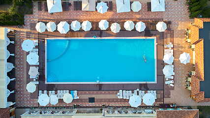 Image showing Aerial view on people in swimming pool. Top view of people sunbathing pool.