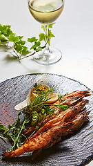 Image showing Grilled shrimp skewers. Seafood, shelfish. Shrimps Prawns skewers with herbs, garlic and lemon.