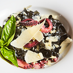 Image showing Pasta with black cuttlefish ink, octopuses and parmesan.