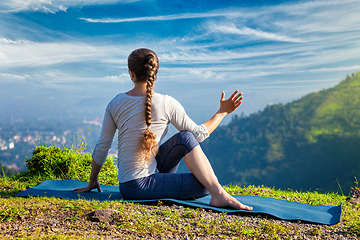 Image showing Woman practices yoga asana Marichyasana