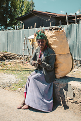Image showing Ethiopian woman resting with sack of charcoal, Ethiopia
