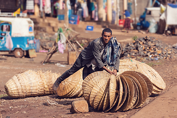 Image showing Ethiopian man sells wicker baskets on the street