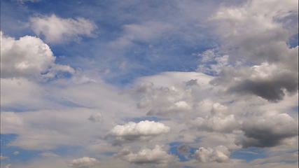 Image showing Time lapse Fluffy clouds float across the blue sky. UltraHD stock footage