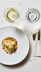 Image showing Close-up italian pasta plate with grated parmesan cheese and basil leaf