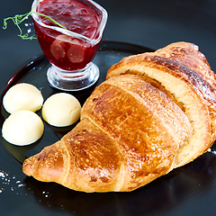 Image showing Closeup of butter, jam and fresh croissants