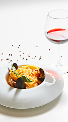 Image showing The cooked mussels and pasta with wine glass.