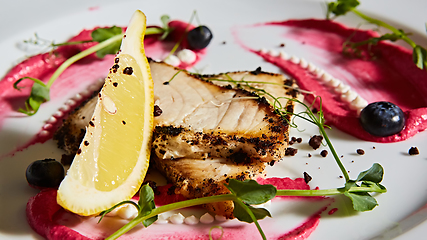 Image showing White fish with lemon on white plate, selective focus