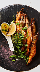 Image showing Grilled shrimp skewers. Seafood, shelfish. Shrimps Prawns skewers with herbs, garlic and lemon.