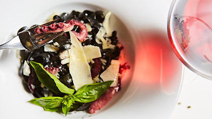 Image showing Pasta with black cuttlefish ink, octopuses and parmesan.