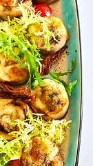 Image showing Fried scallops with butter lemon spicy sauce served with green salad. Top view, copy space.