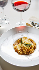 Image showing Close-up italian pasta plate with grated parmesan cheese and basil leaf