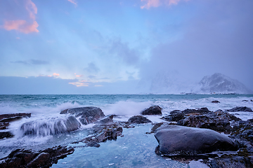 Image showing Coast of Norwegian sea on rocky coast in fjord on sunset