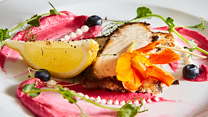 Image showing White fish with lemon on white plate, selective focus