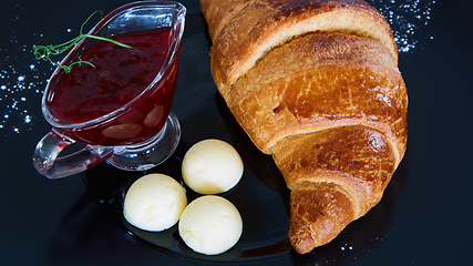 Image showing Closeup of butter, jam and fresh croissants