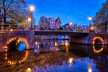 Image showing Amterdam canal, bridge and medieval houses in the evening