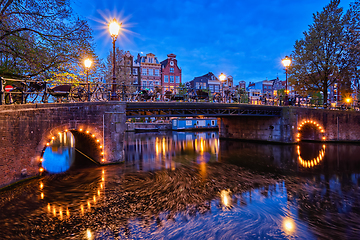 Image showing Amterdam canal, bridge and medieval houses in the evening