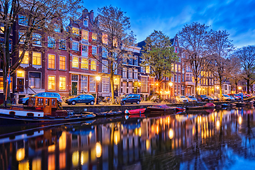 Image showing Amterdam canal, boats and medieval houses in the evening