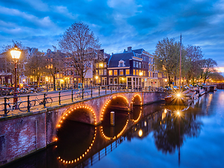 Image showing Amterdam canal, bridge and medieval houses in the evening