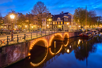 Image showing Amterdam canal, bridge and medieval houses in the evening