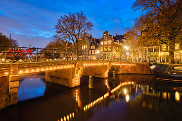 Image showing Amterdam canal, bridge and medieval houses in the evening