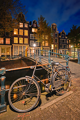 Image showing Amterdam canal, bridge and medieval houses in the evening