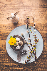 Image showing Easter table setting with spring flowers and cutlery on wooden table