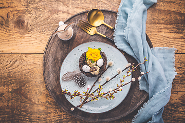 Image showing Easter table setting with spring flowers and cutlery on wooden table